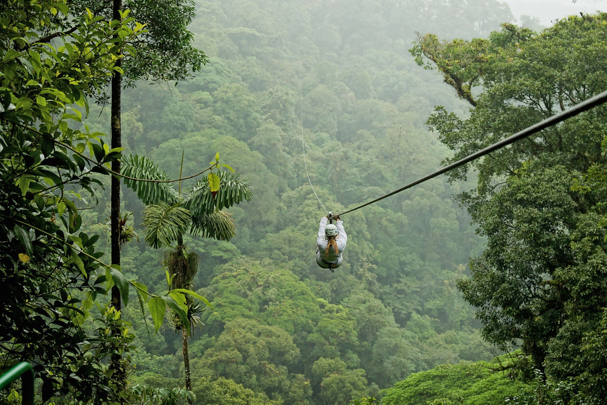 A person zip lining above a forest in Costa Rica.