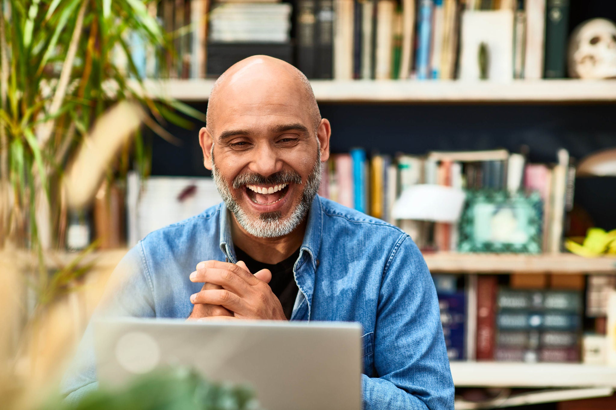 mature-man-laughing-and-smiling-on-video-conference