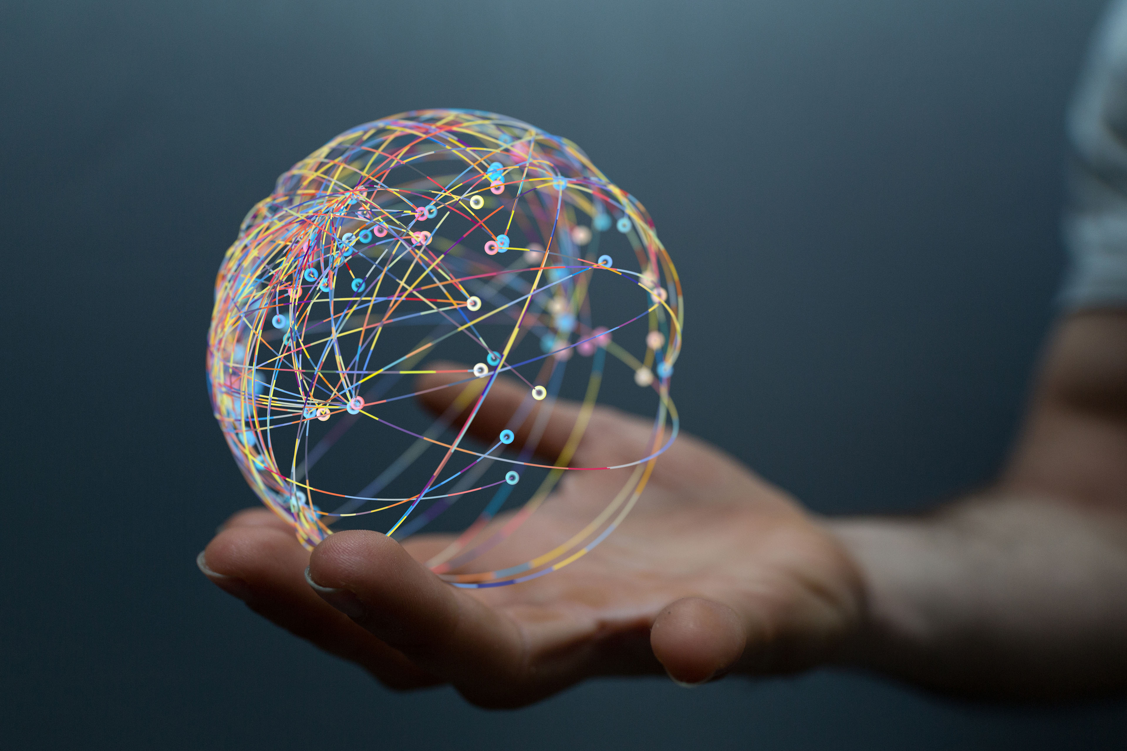  A hand holding a 3d Global Network model