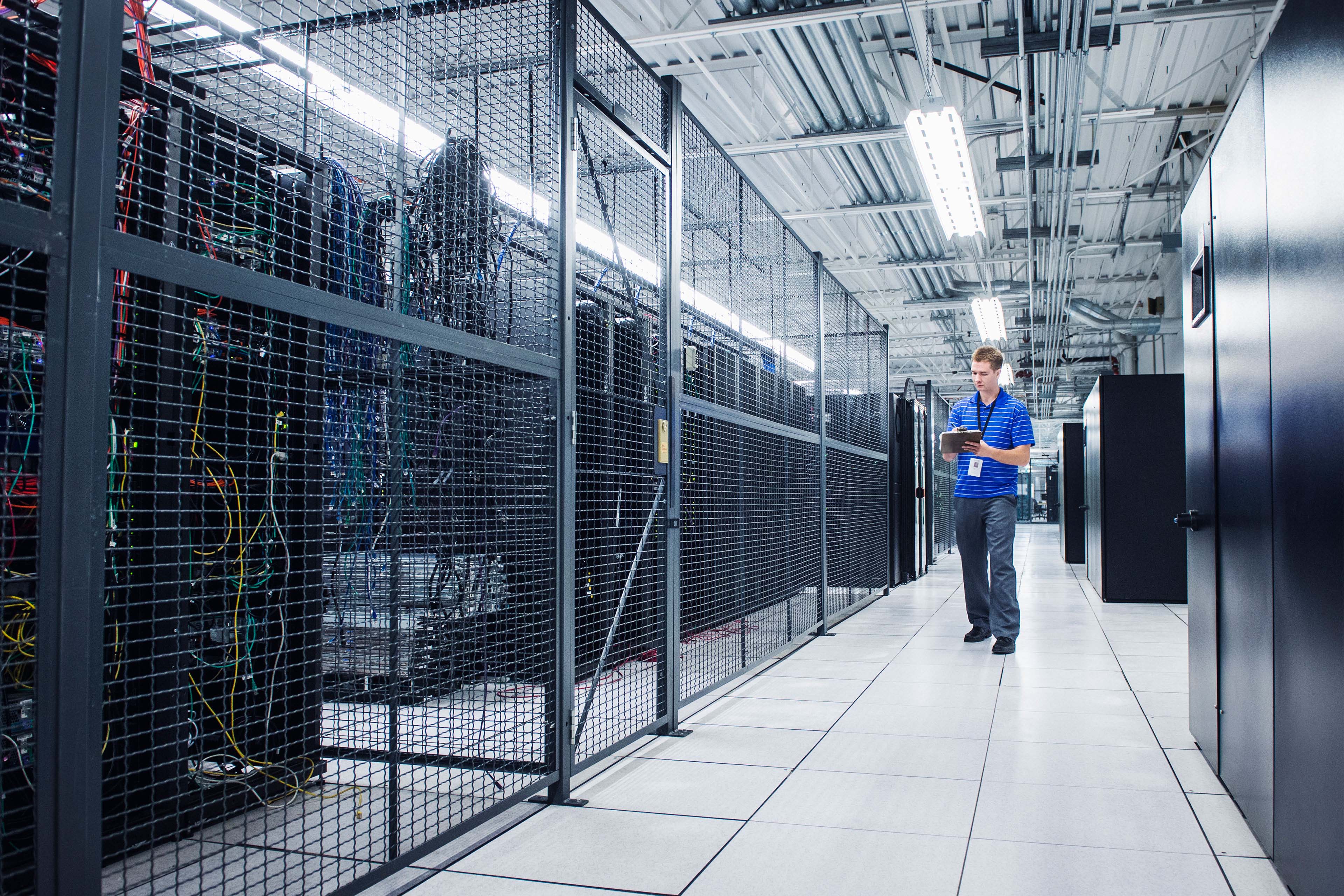 Caucasian technician using digital tablet in server room